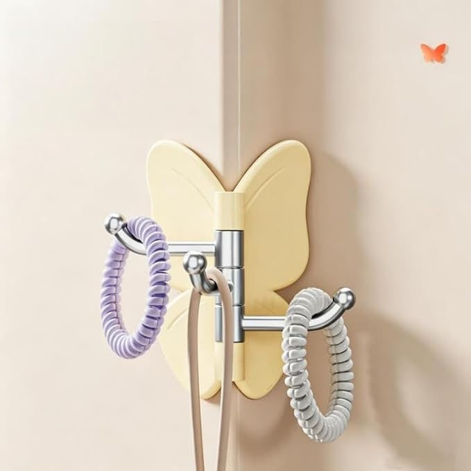 Self adhesive butterfly hook holding coat on wall