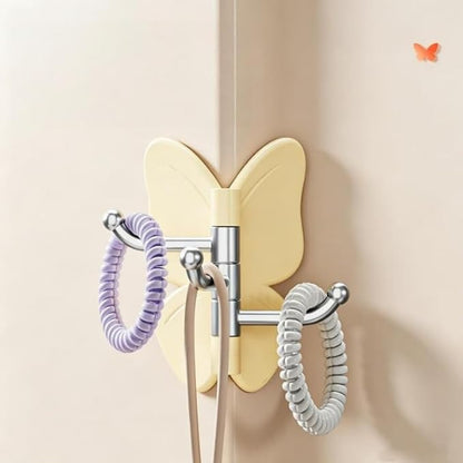 Self adhesive butterfly hook holding coat on wall